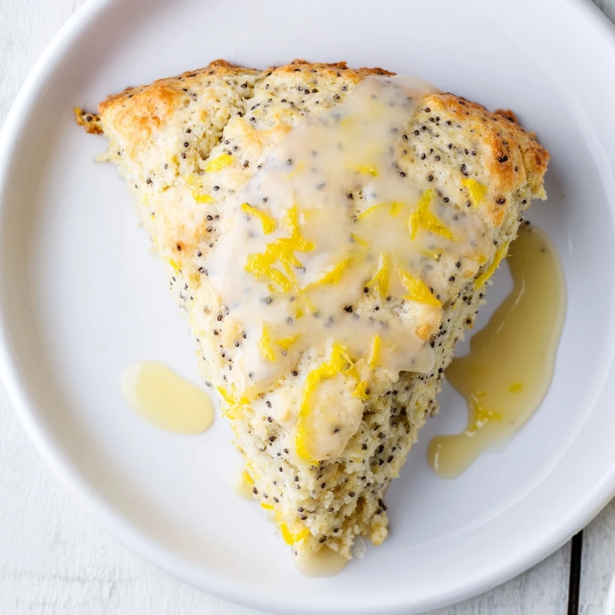Warm Lemon Poppy Seed Scones with lemony glaze ready to serve with morning coffee.