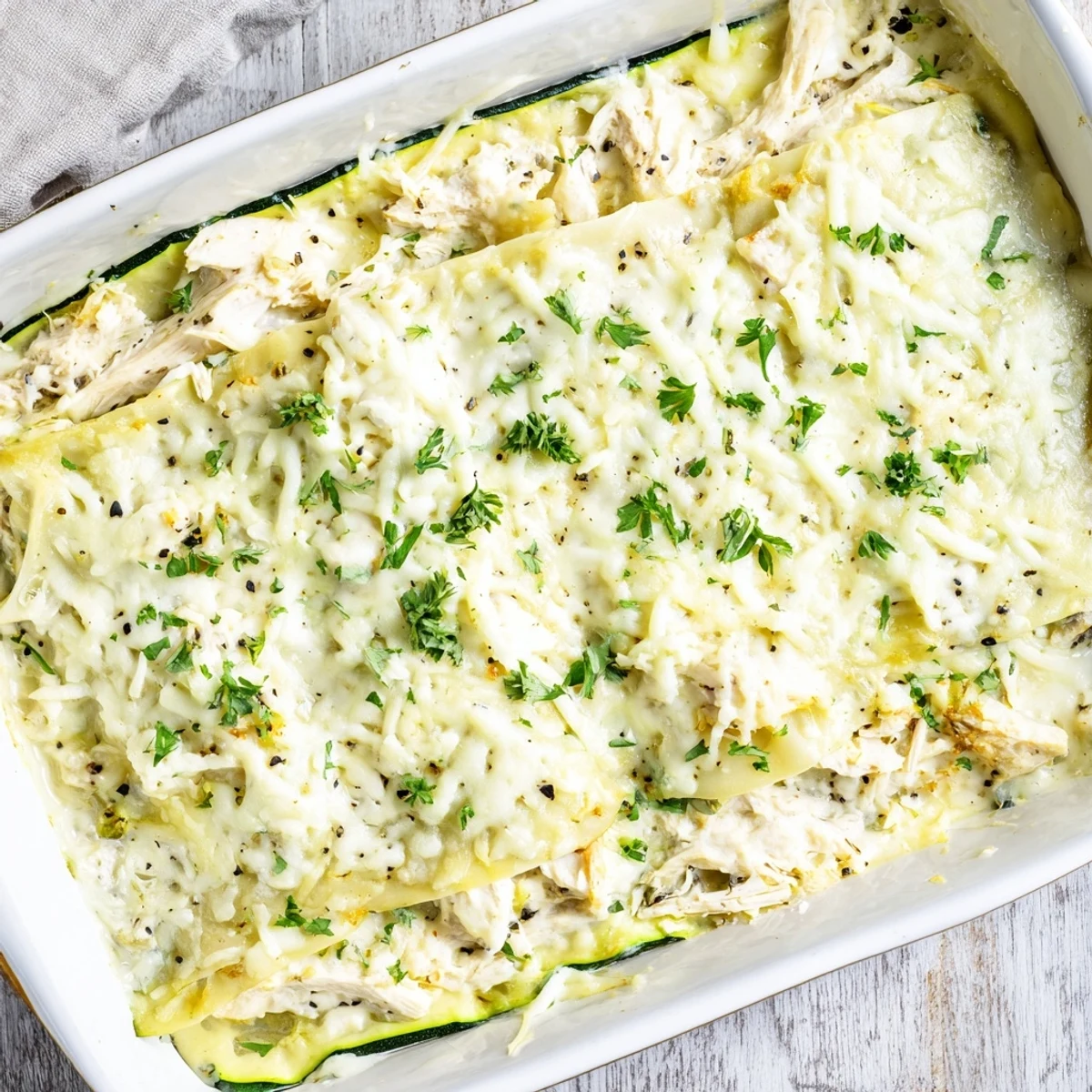Freshly baked Chicken Alfredo Zucchini Lasagna with melted mozzarella and golden edges.