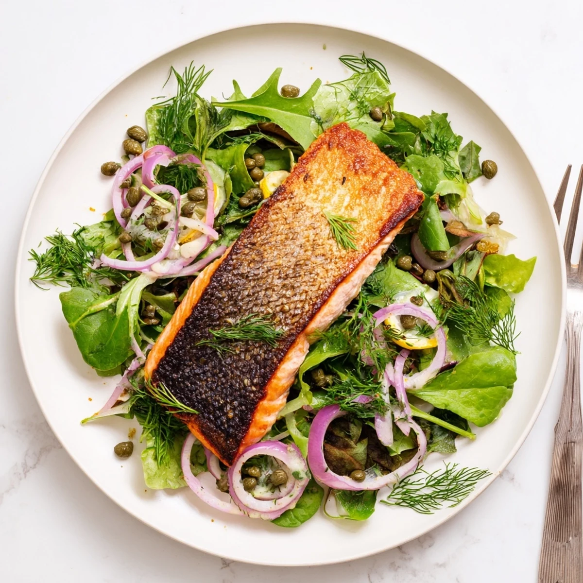 Crispy Skin Tasmanian Atlantic Salmon fillets rest on a vibrant lemon herb salad, ready to serve.