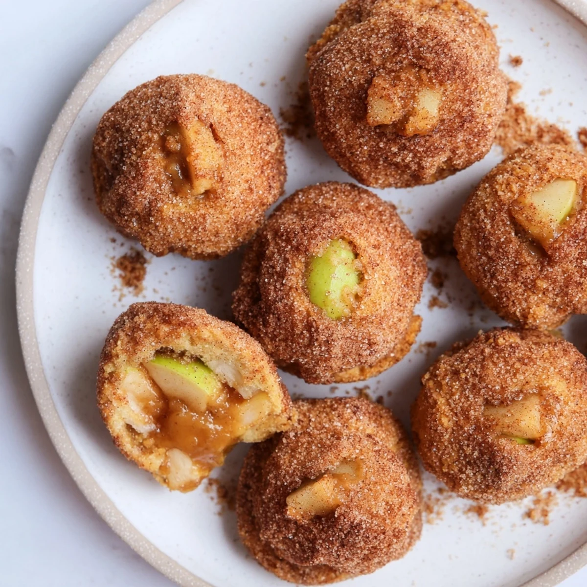 Baked simple caramel apple pie bombs coated in cinnamon sugar and melted butter