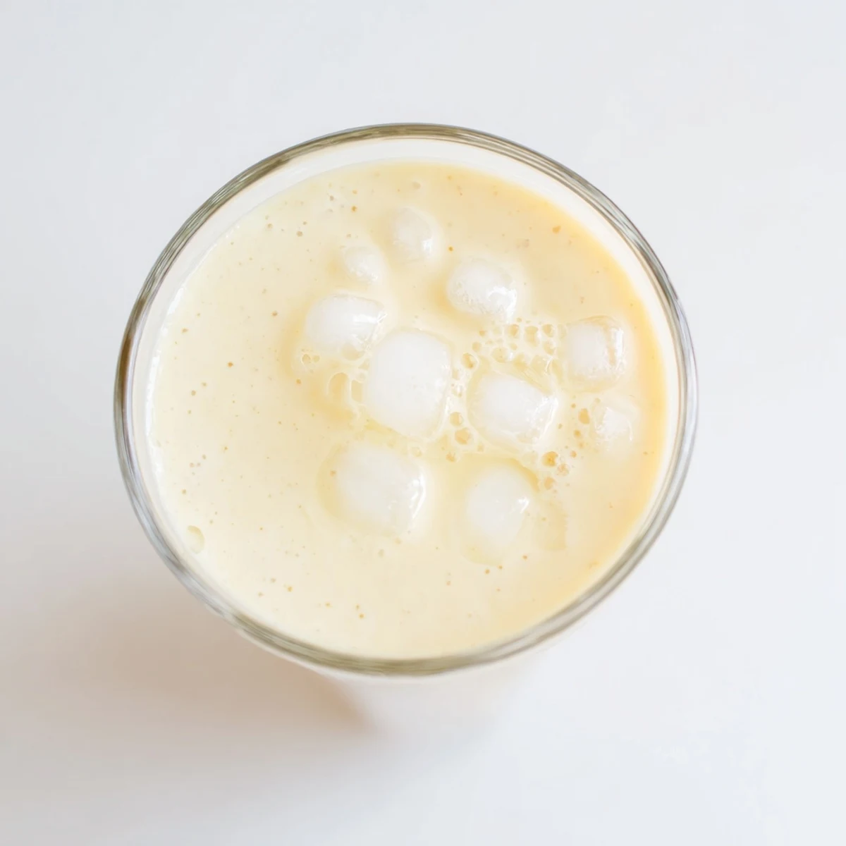 Thick tropical durian smoothie topped with ice and served chilled in tall glasses.