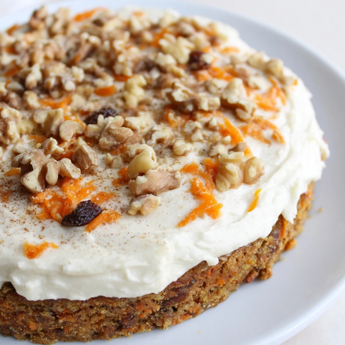 Soft carrot cake cookies topped with creamy cream cheese frosting and walnuts
