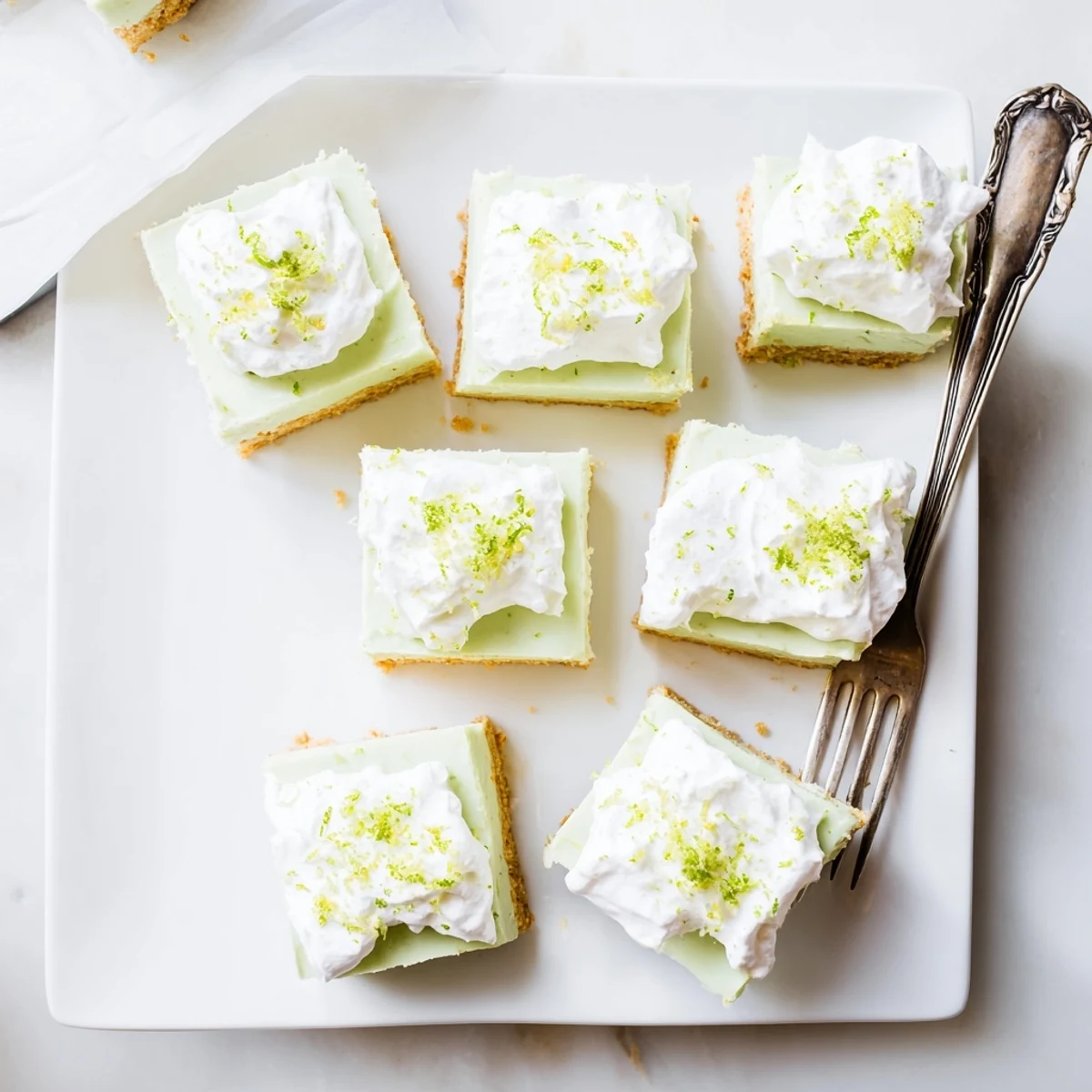 Creamy Key Lime Pie Bars feature a rich green filling atop a buttery graham cracker crust