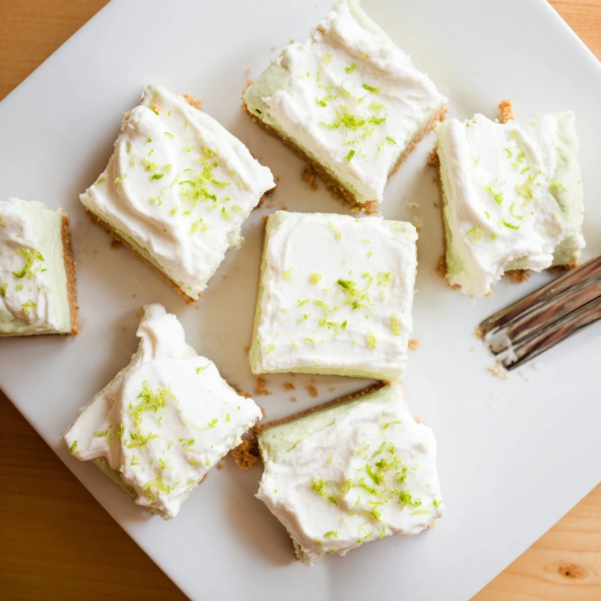 Sliced Key Lime Pie Bars showing their smooth lime center and crumbly base ready for serving