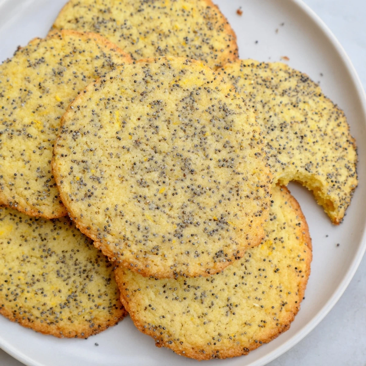 Assorted spring cookie collection featuring lemon poppy seed, matcha almond, and strawberry white chocolate varieties arranged on a wooden serving board