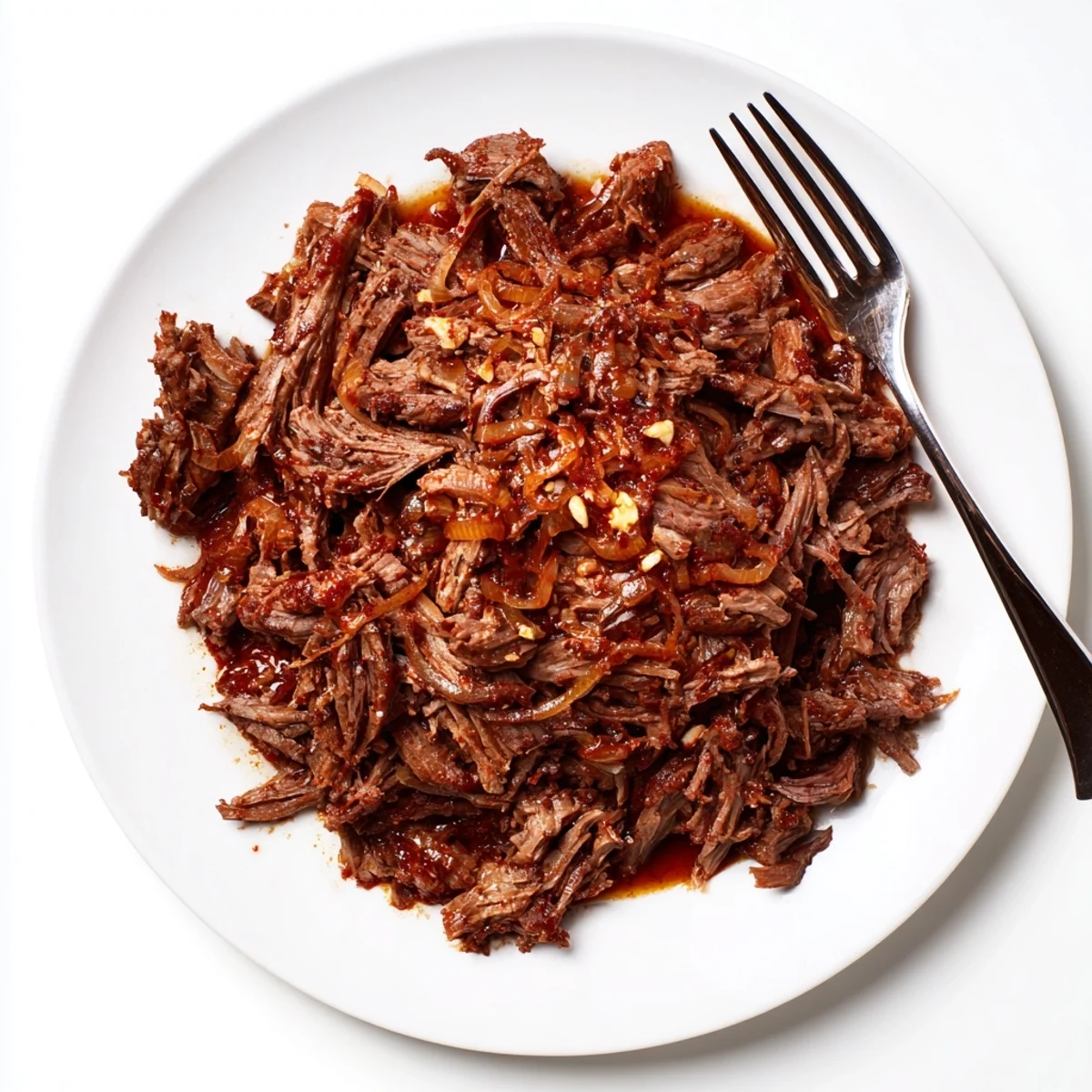 Tender Crock Pot shredded beef with fork-flaky meat in rich dark gravy