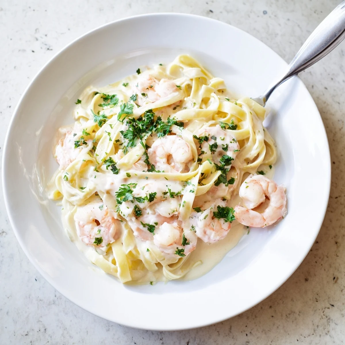 Creamy one pan shrimp fettuccine Alfredo with tender pink shrimp in rich Parmesan garlic sauce