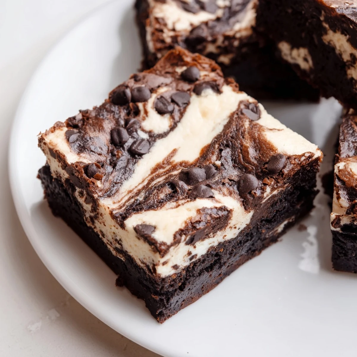 Fudgy cottage cheese brownies with creamy white swirls baked in a square pan