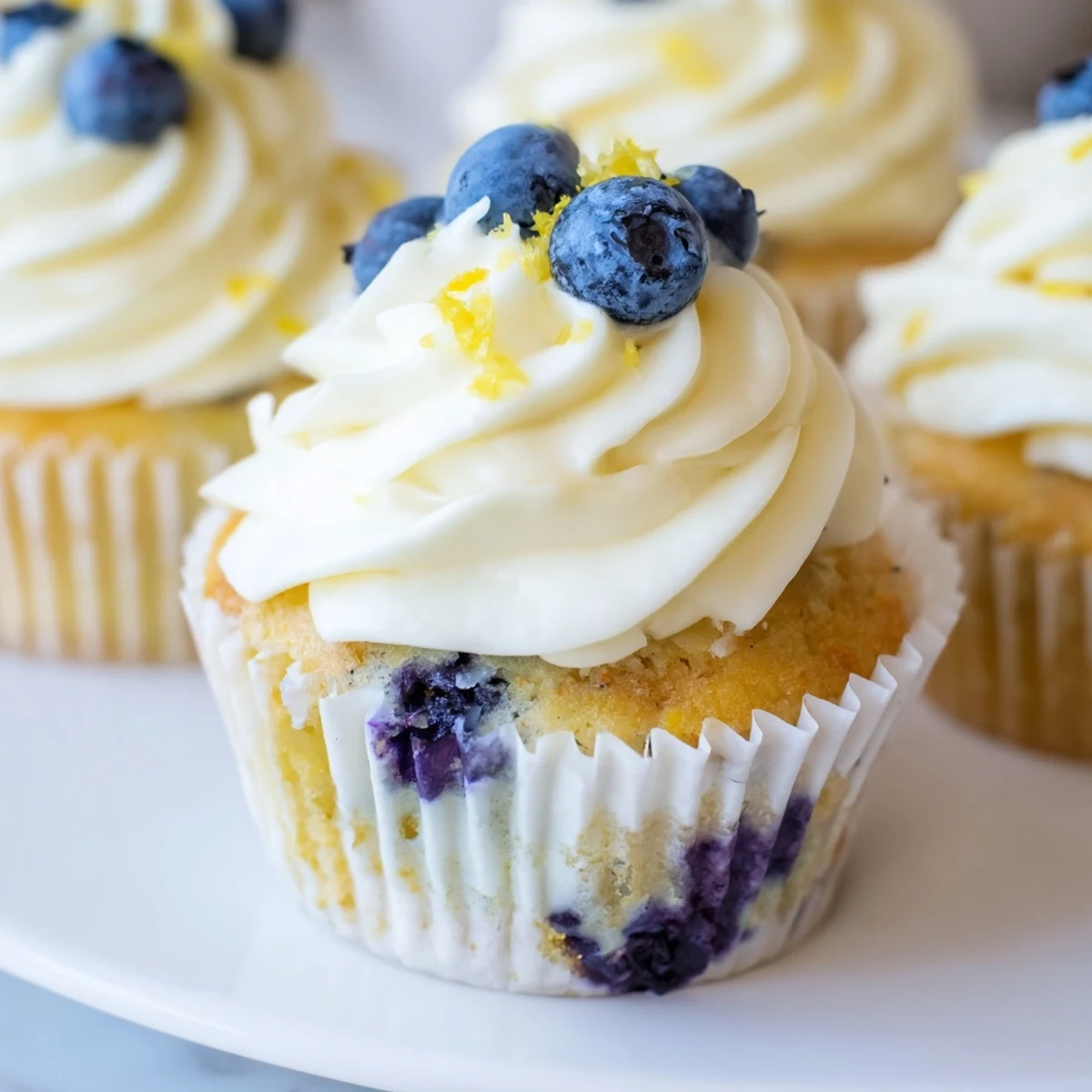 Golden lemon blueberry cupcakes with zesty frosting bursting with juicy fresh blueberries
