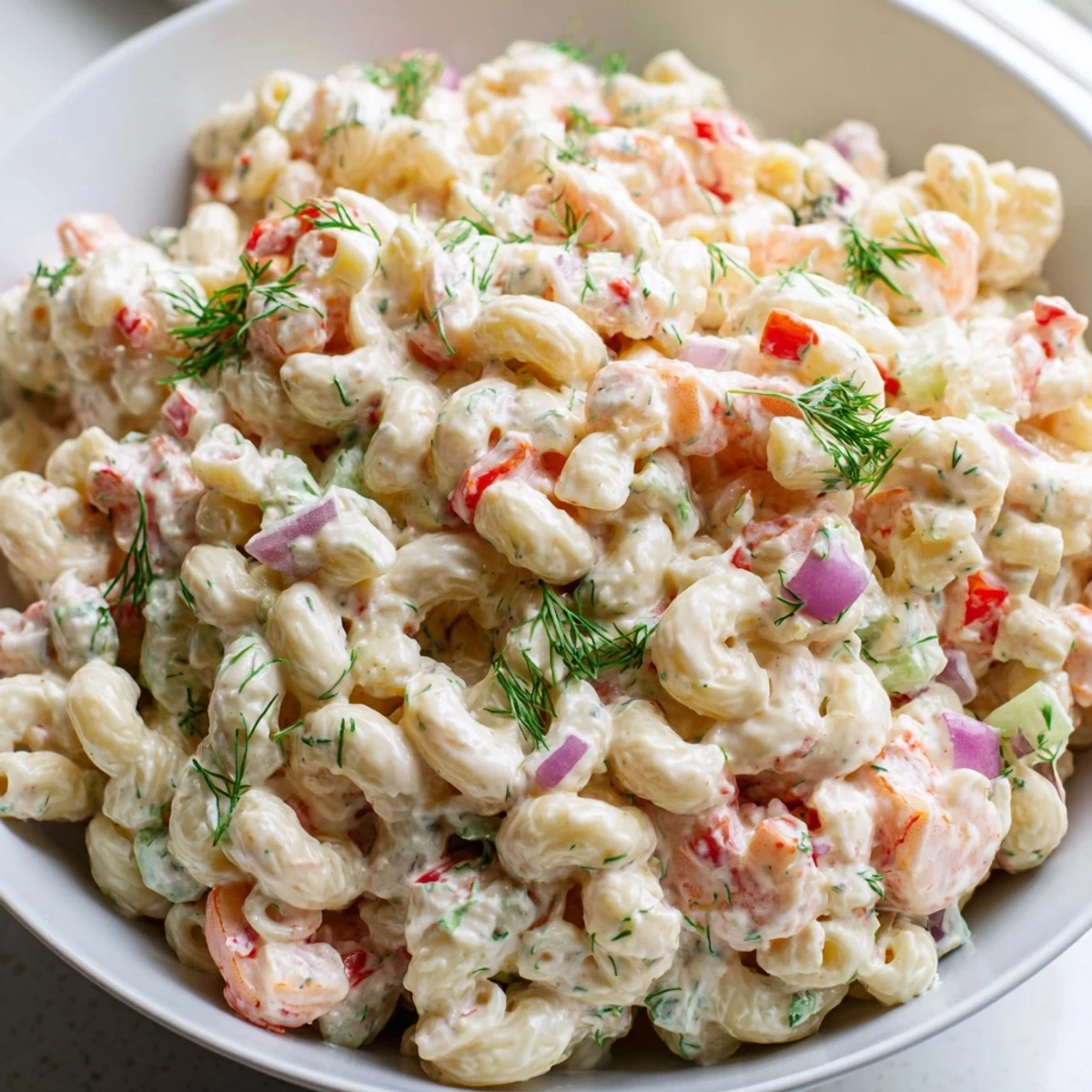Creamy shrimp macaroni salad loaded with tender shrimp and crunchy vegetables in a chilled bowl