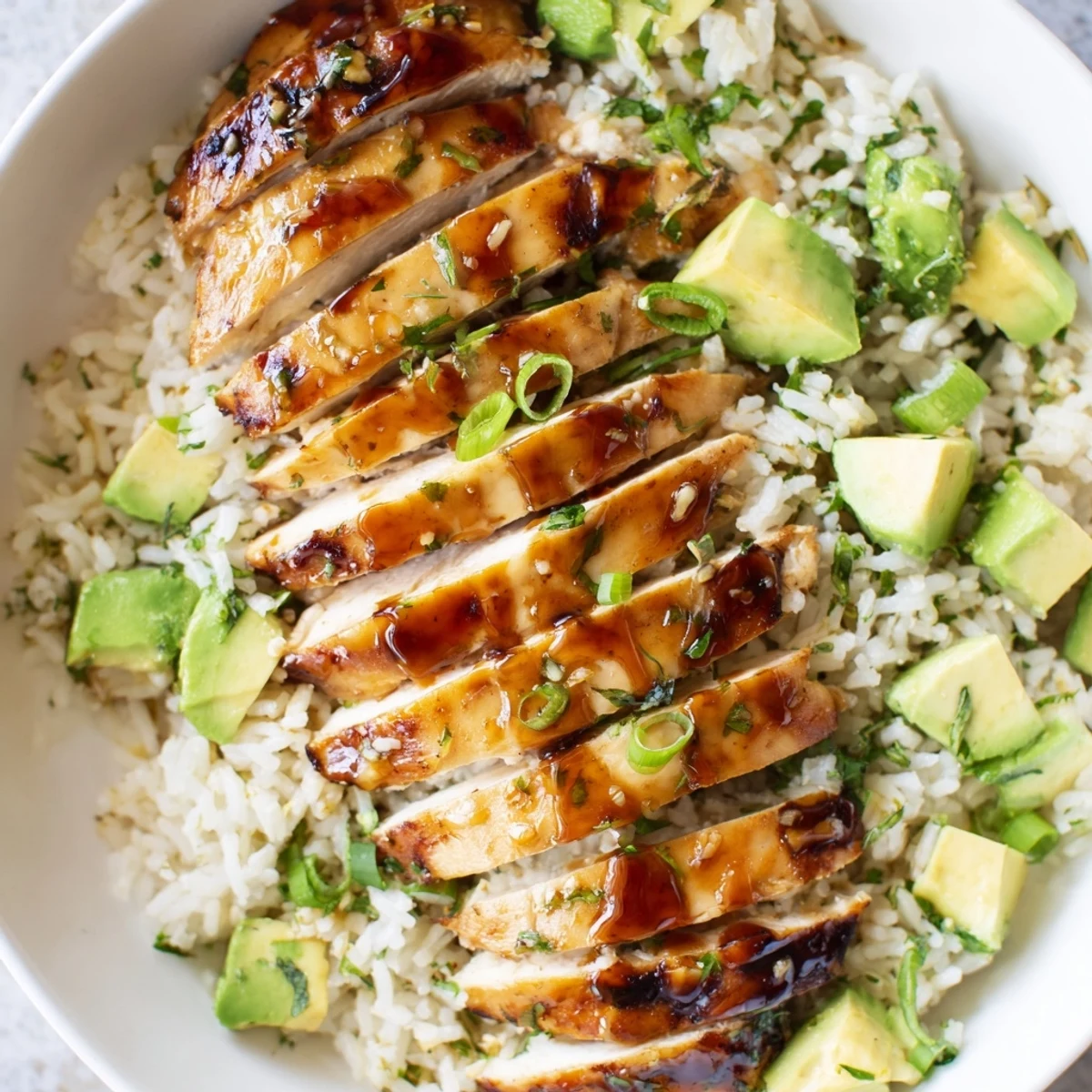 Golden honey lime chicken sliced and served over creamy green avocado rice with fresh cilantro