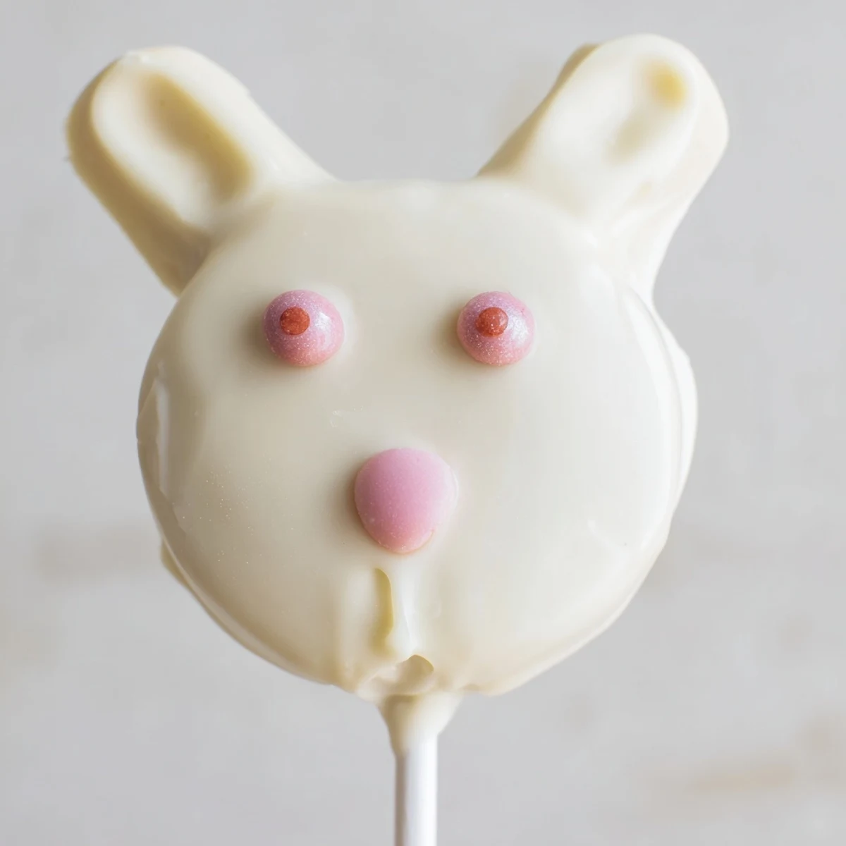 Creamy white chocolate bunny cakesicles decorated with sprinkles for festive Easter dessert fun