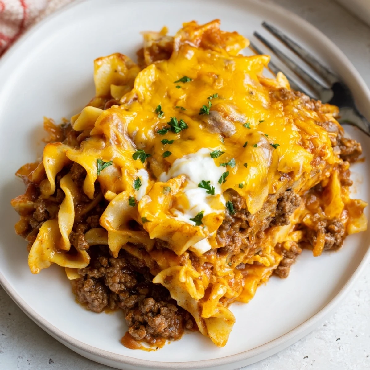 Homestyle Beef Noodle Casserole served steaming with garlic bread on wooden table