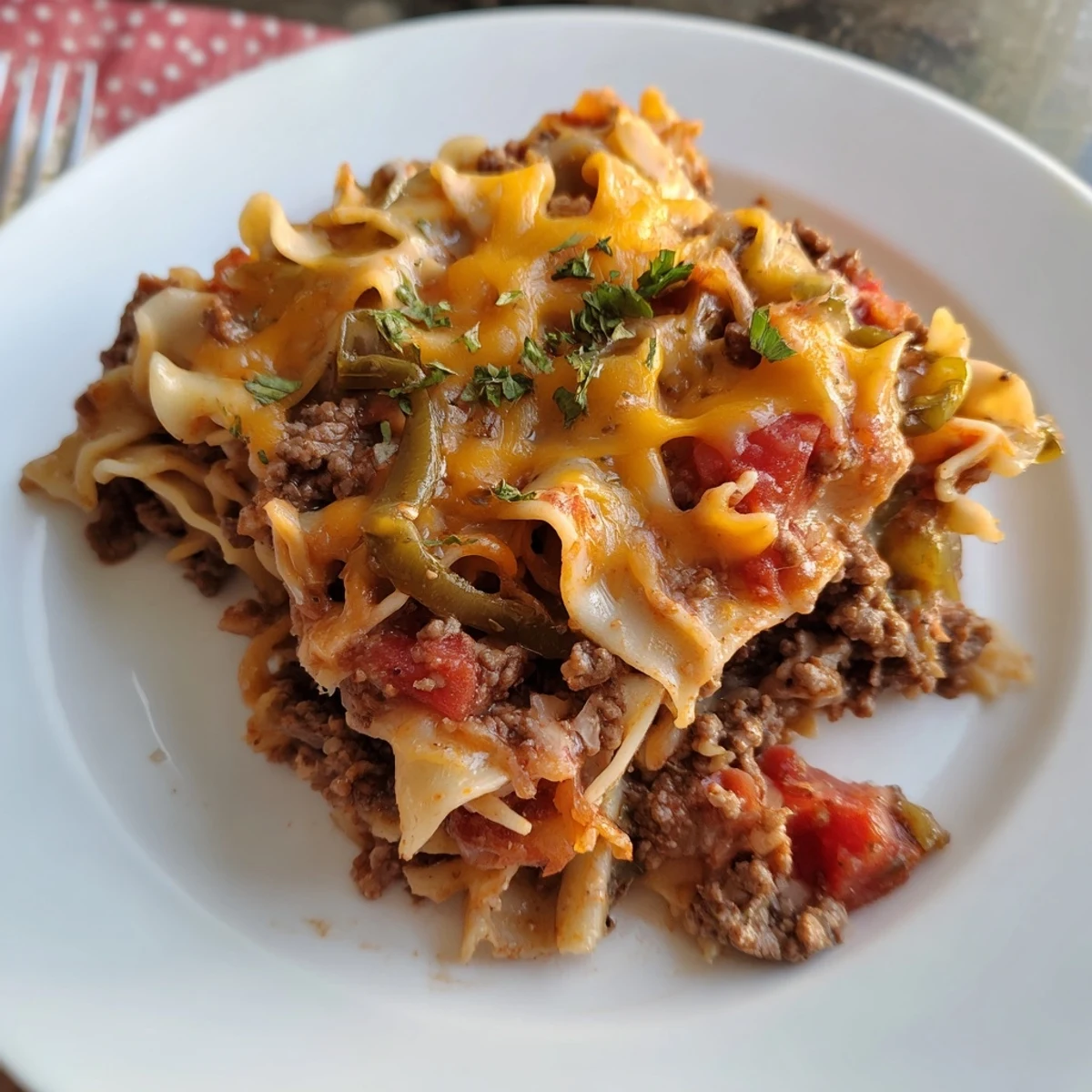 Cheesy Beef Noodle Casserole spoonful showing tender beef, saucy noodles, comforting aroma