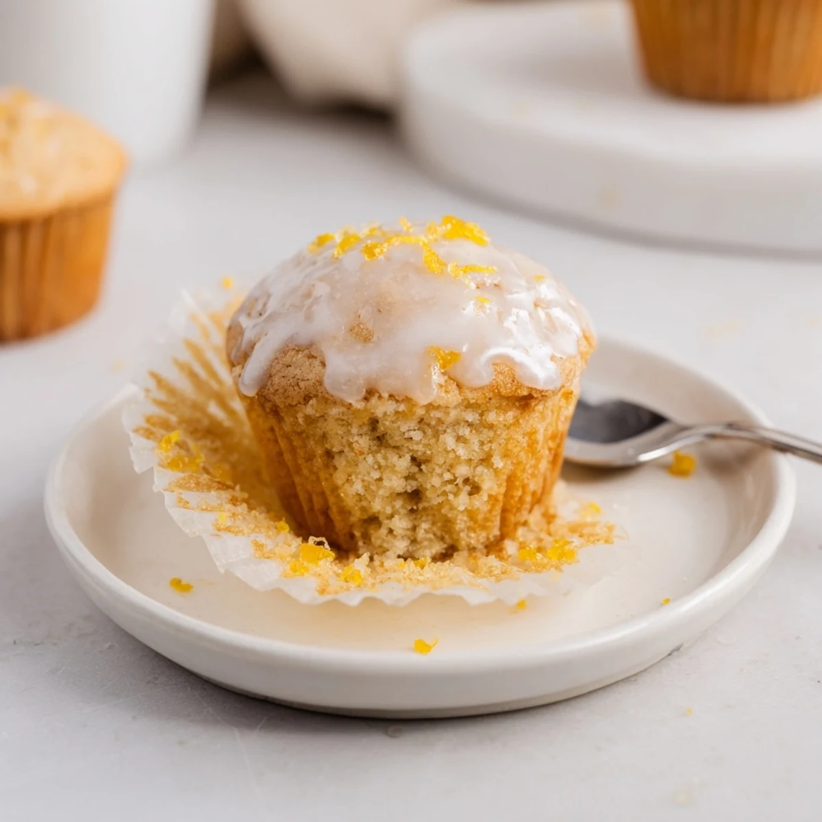 Glazed Lemon Ginger Muffins with golden, domed tops and zesty lemon-ginger aroma.