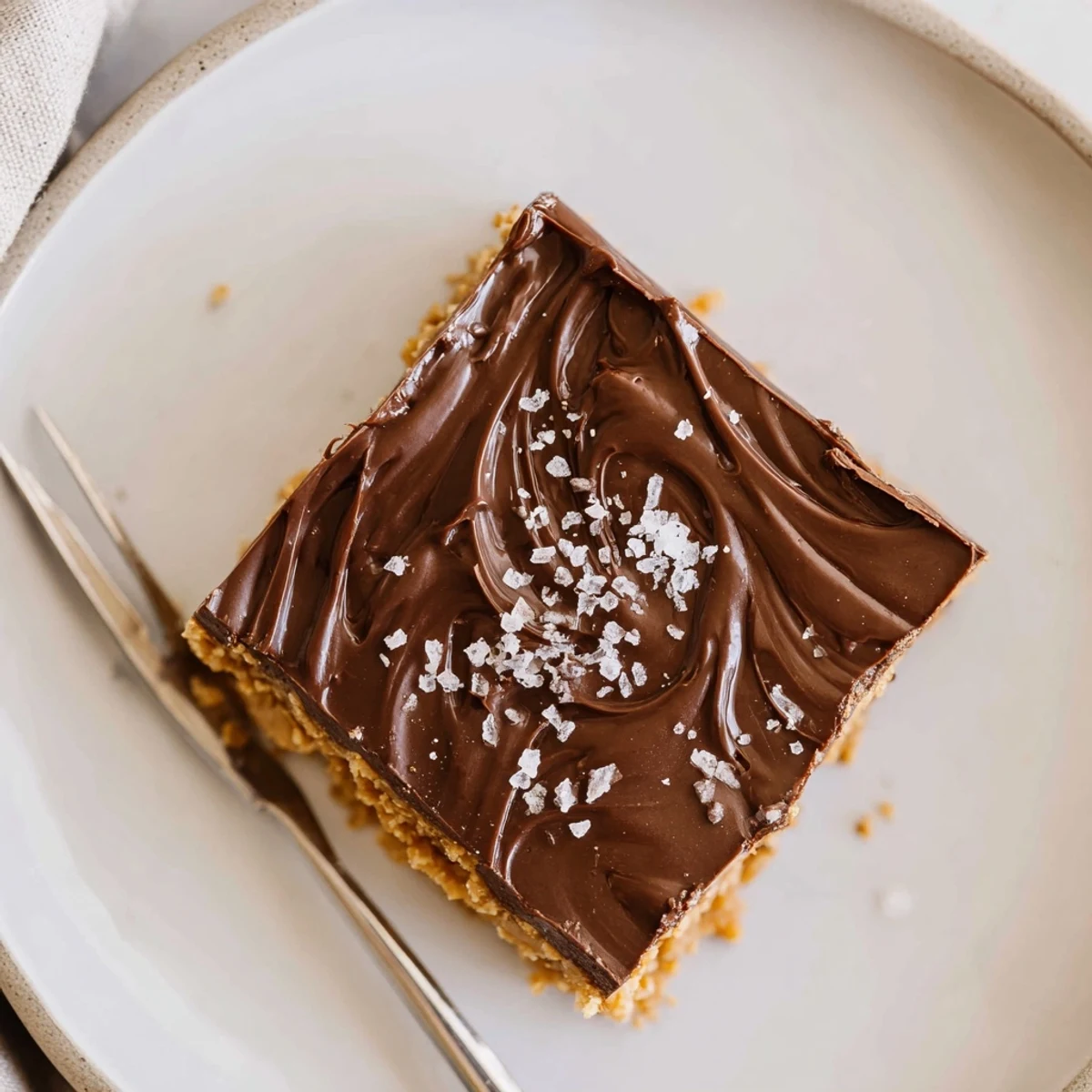 No Bake Peanut Butter Bars chilled on parchment, glossy chocolate topping, nutty aroma