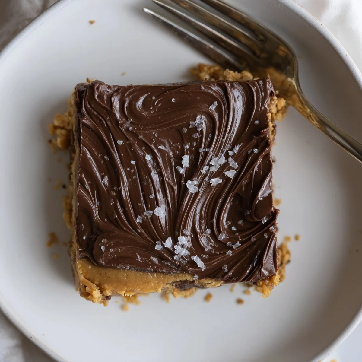 Sliced No Bake Peanut Butter Bars on plate, creamy center, sprinkle sea salt