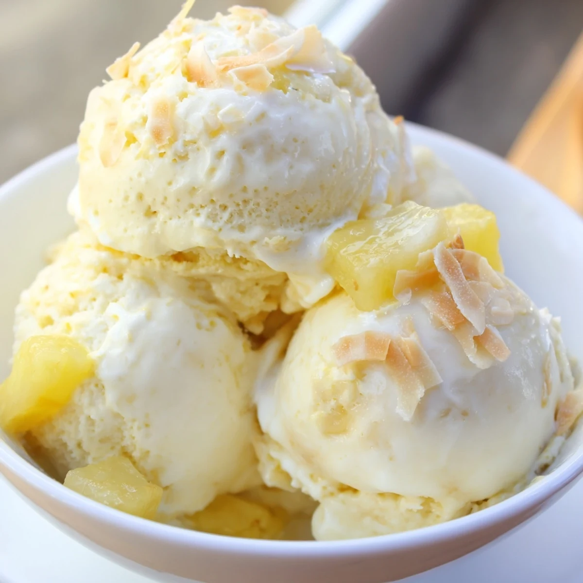 Creamy Pineapple Ice Cream scoops glistening, tropical aroma, perfect for summer