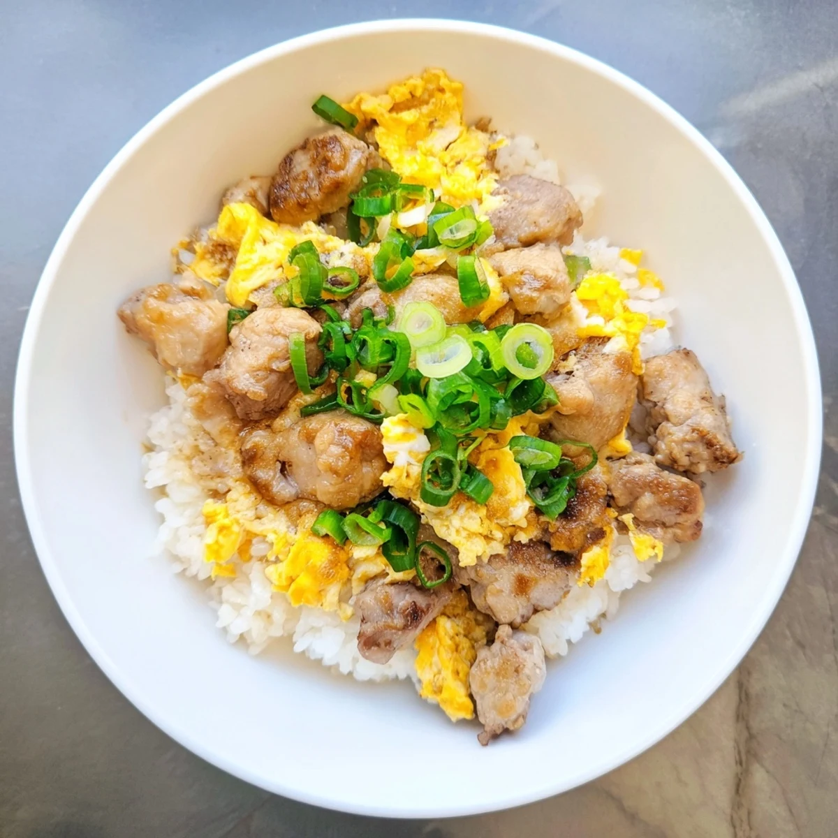 Savory One Pot Oyakodon simmered in sweet soy dashi sauce over steaming Japanese white rice