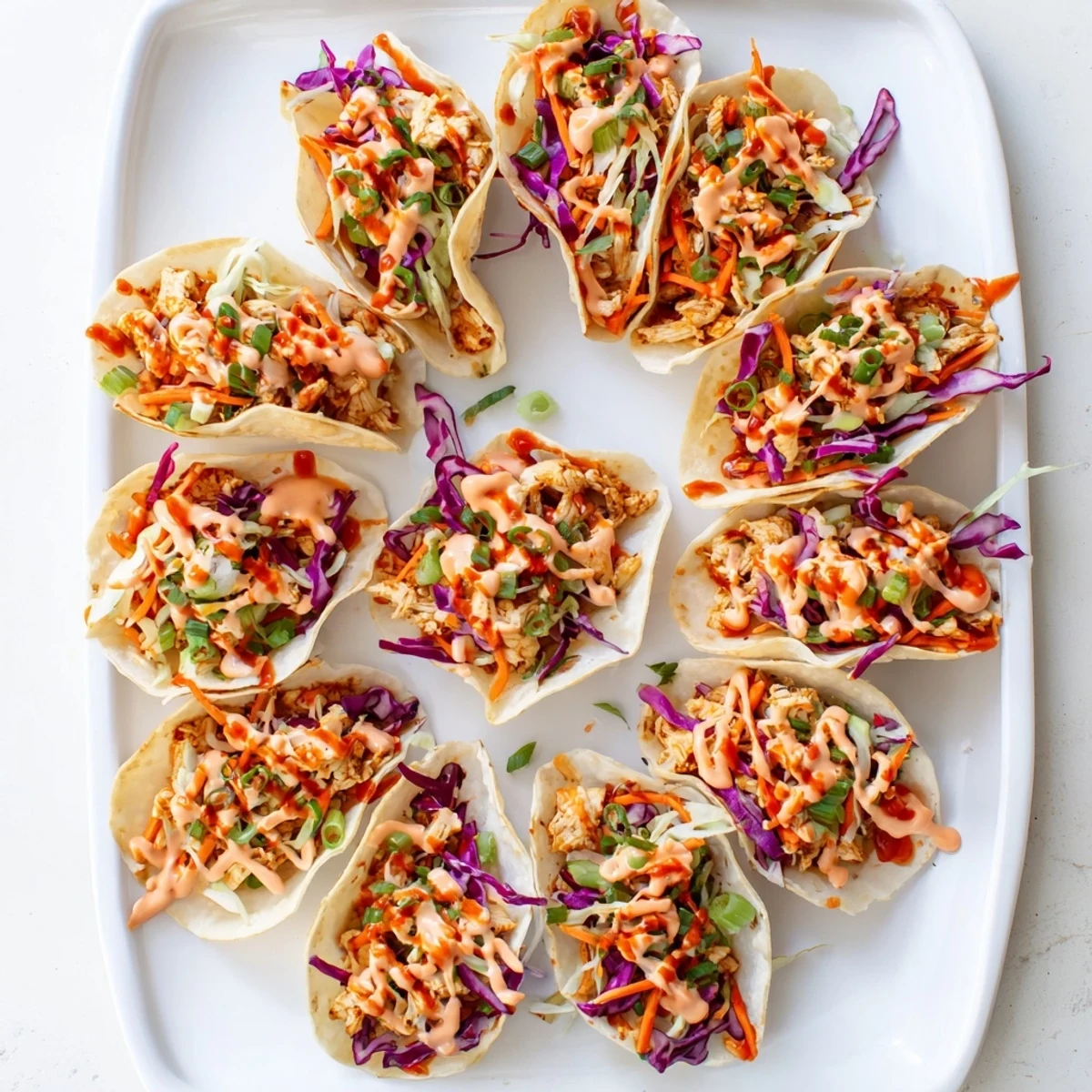 Crispy baked wonton shells filled with savory marinated chicken topped with fresh tangy cabbage slaw