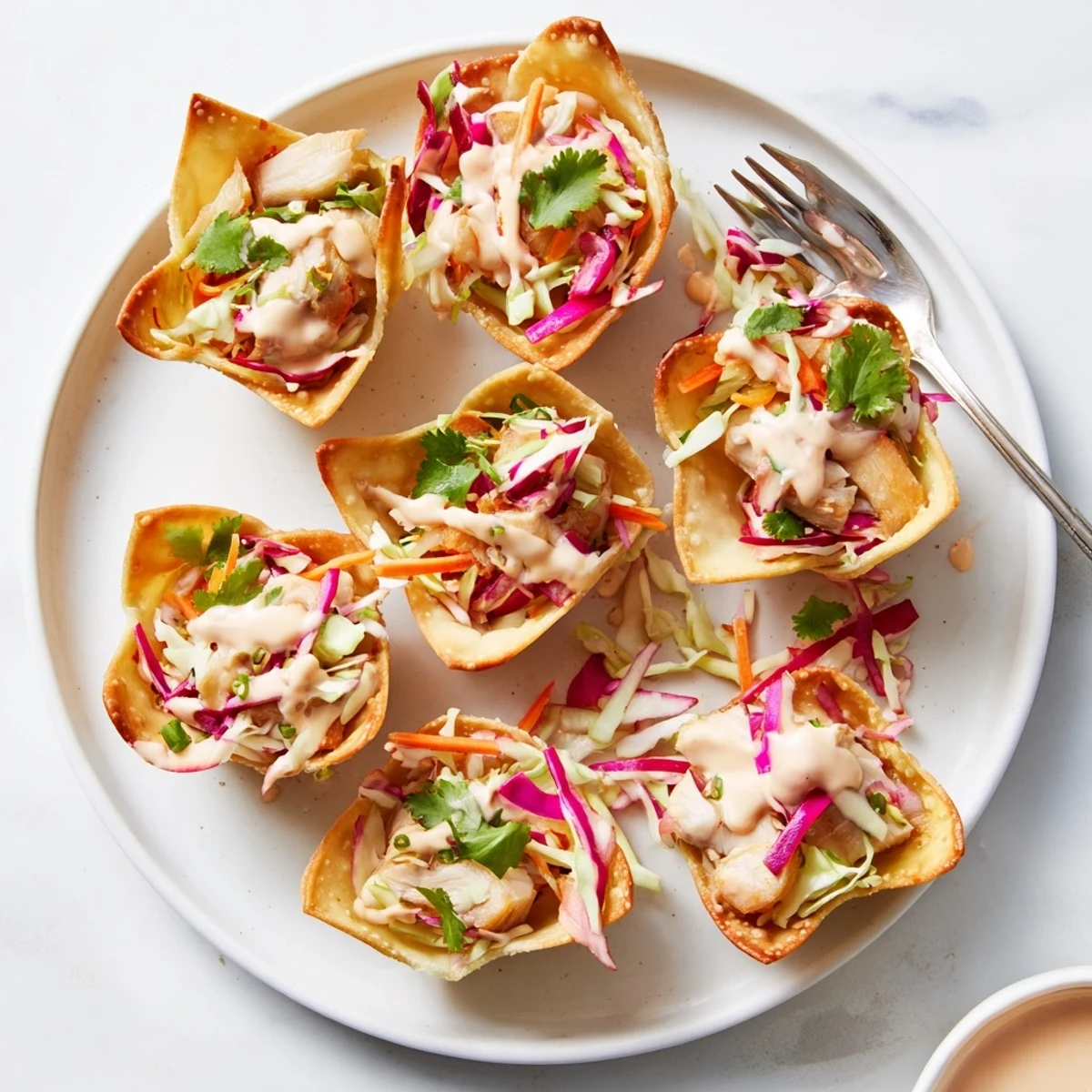 Golden crispy Asian chicken wonton tacos filled with tender spiced chicken and colorful crunchy vegetable slaw