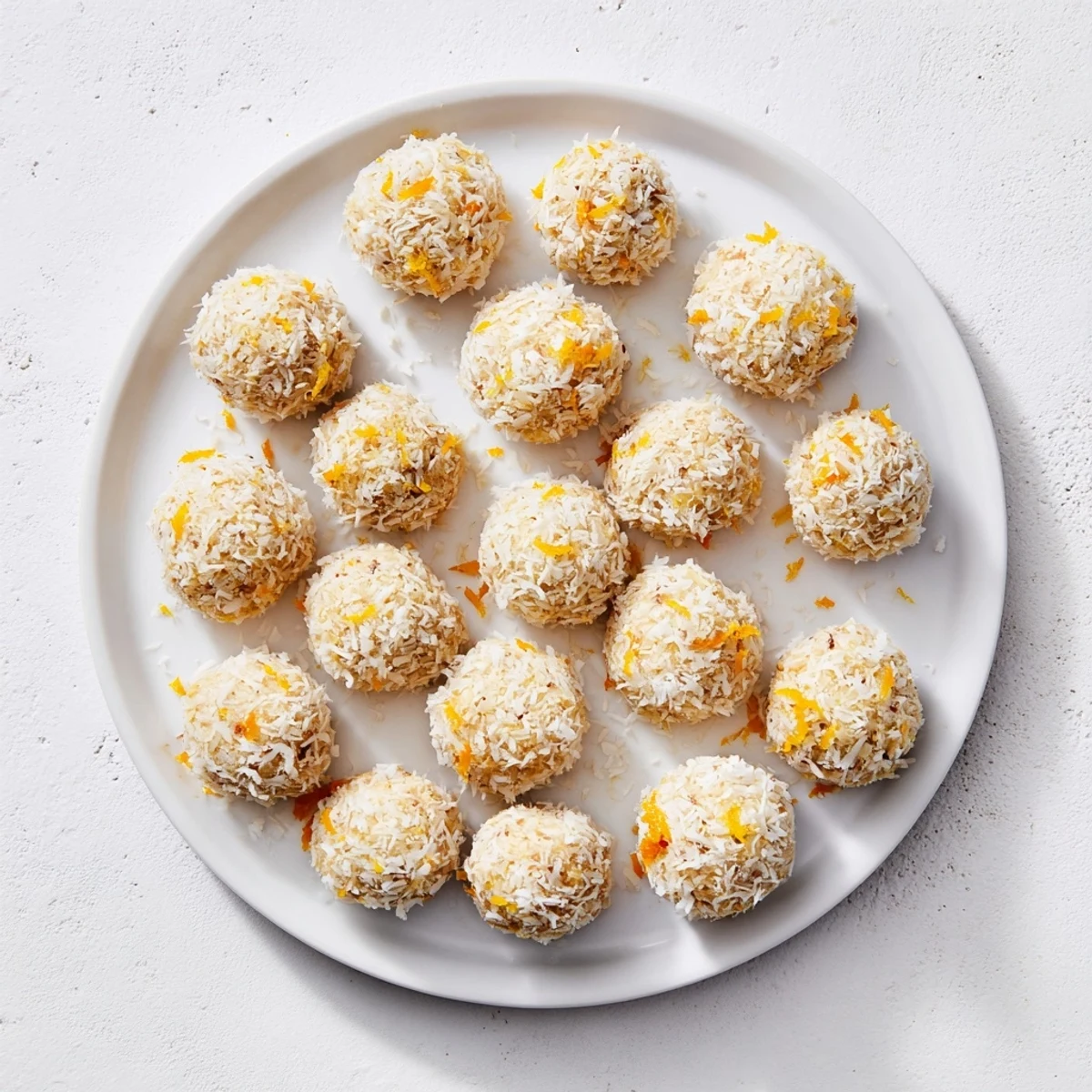 Fresh orange and lemon zest speckled Citrus Bliss Bits arranged on a wooden board for party guests