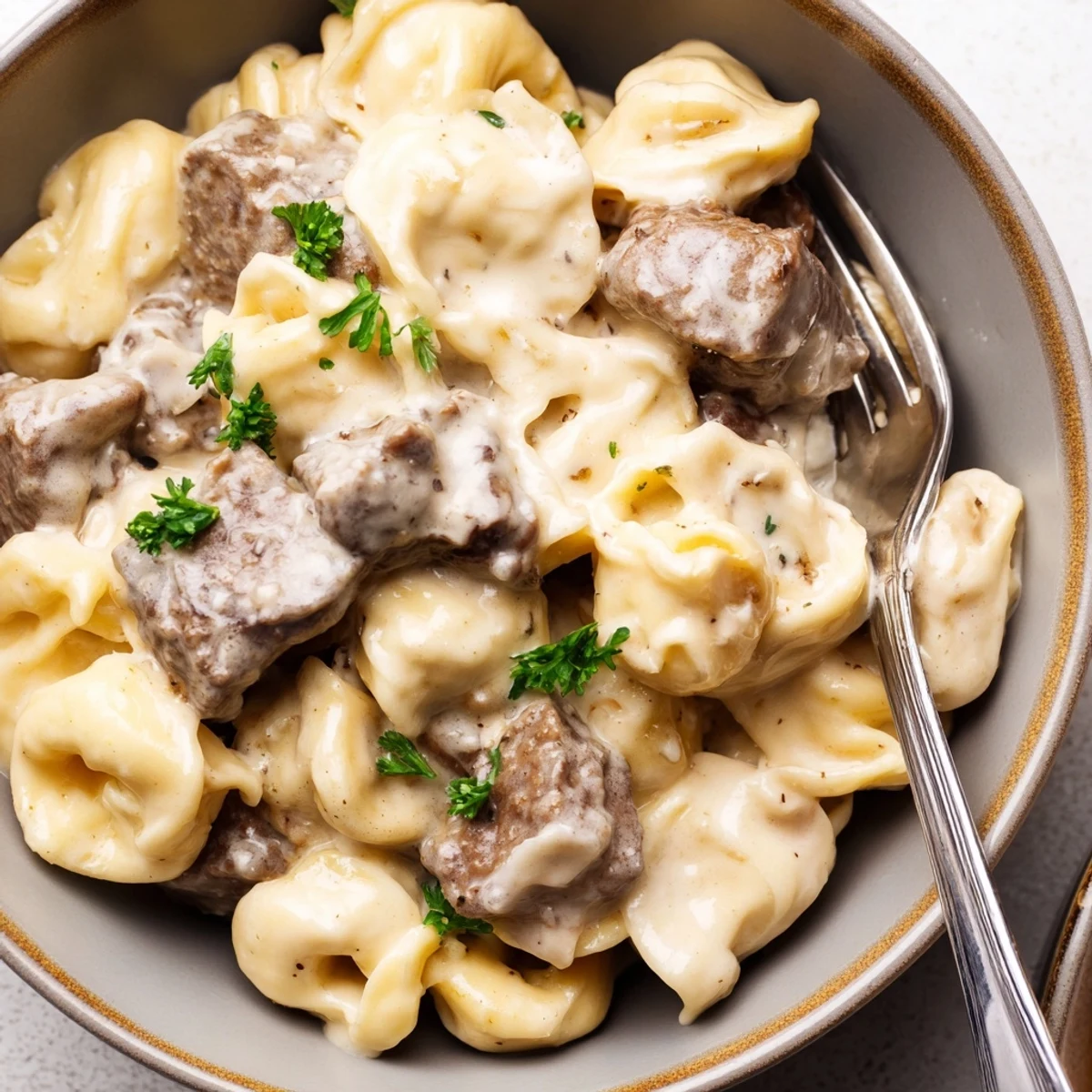 Succulent steak bites and cheese tortellini coated in a rich garlic Parmesan cream sauce  