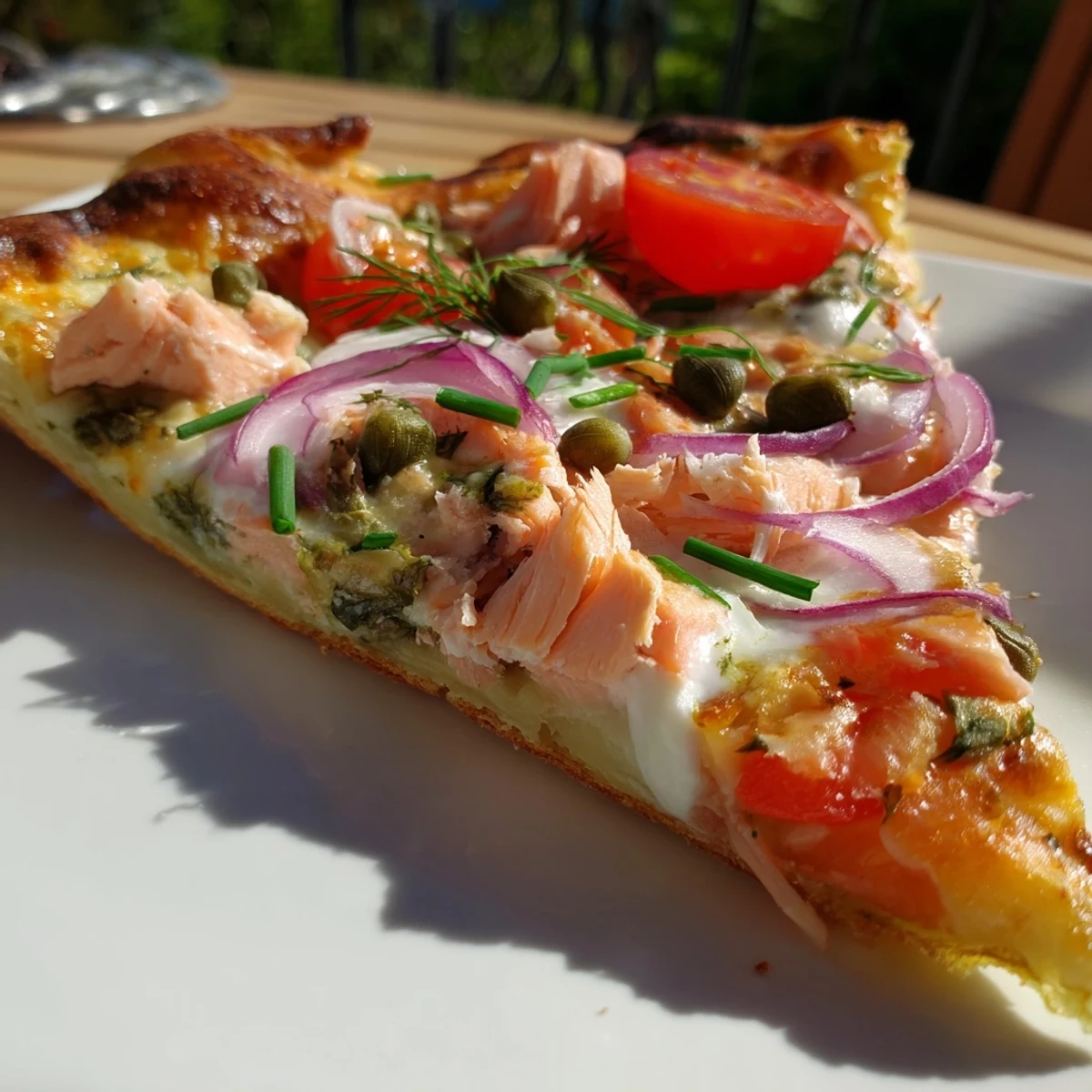 Quick and easy leftover salmon tortilla pizza served with lemon wedges and fresh chives for a light meal.