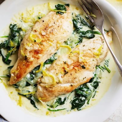 Golden seared chicken breast topped with spinach parmesan crust and fresh lemon zest